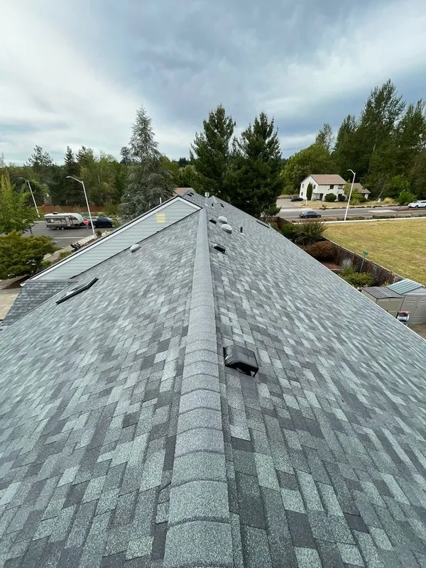 Finished shingle roof under blue sky